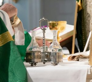 priest wiping chalice