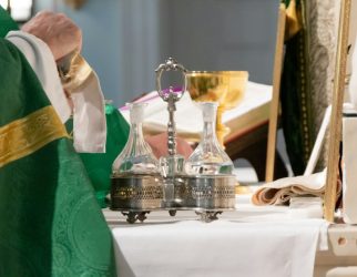 priest wiping chalice