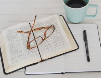 flat lay photography of tortoiseshell eyeglasses on top of book near black pen and teal mug