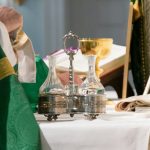 priest wiping chalice